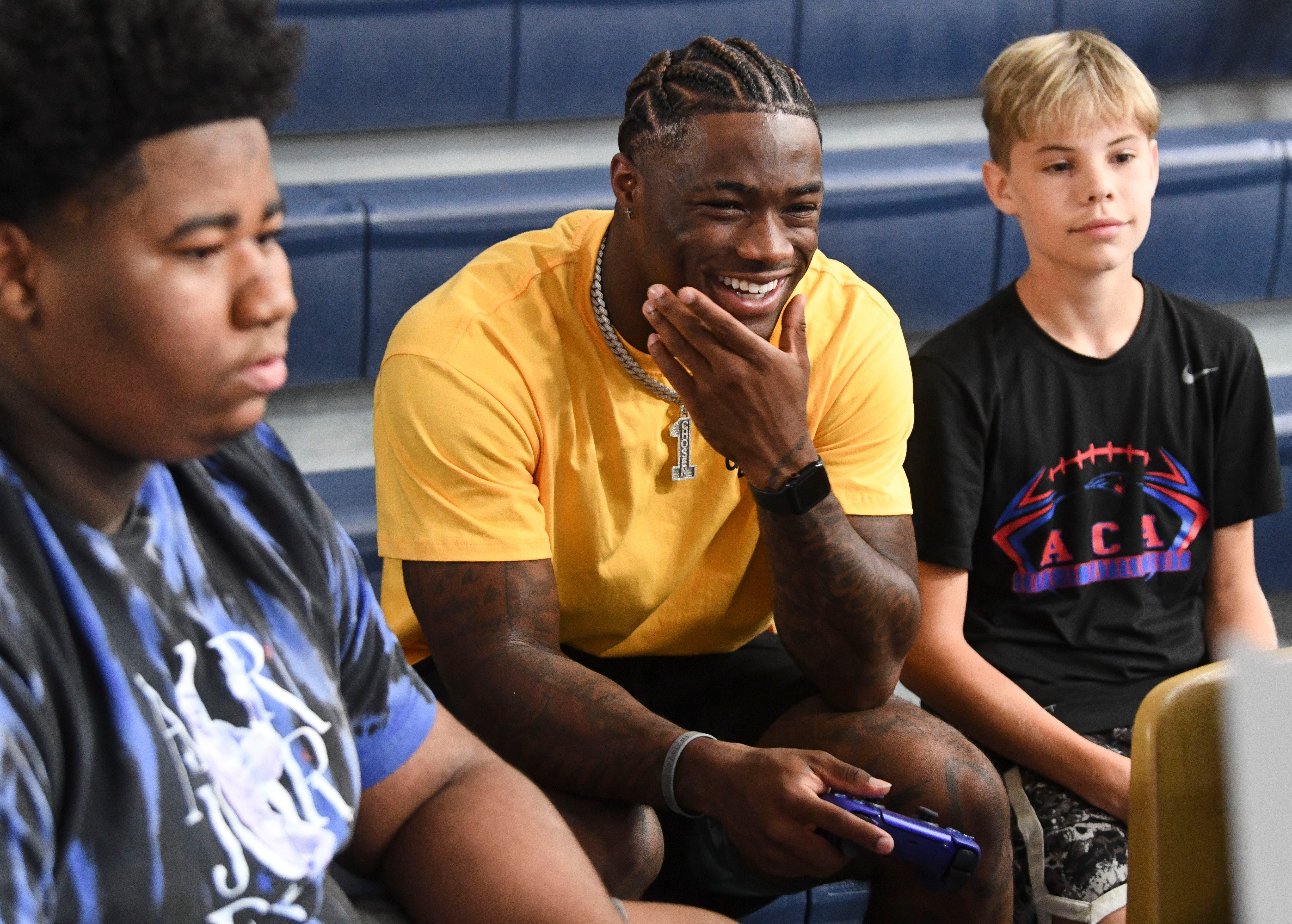 While some College Football 25 players are as delighted as Jalen Milroe, others seem as morose as the youth on his right in this photo. (Image Credit: IMAGN)